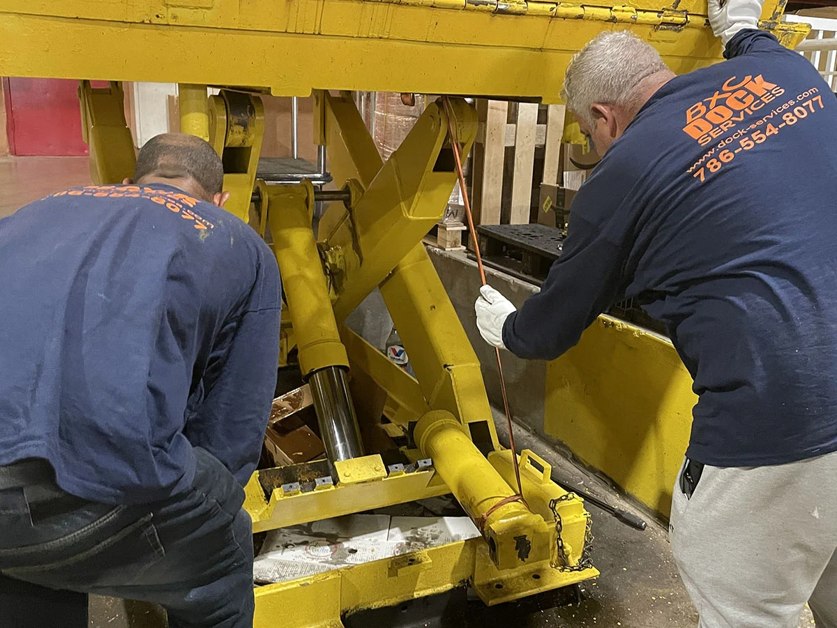 BXC technicians servicing a dock lift cylinder in South Florida