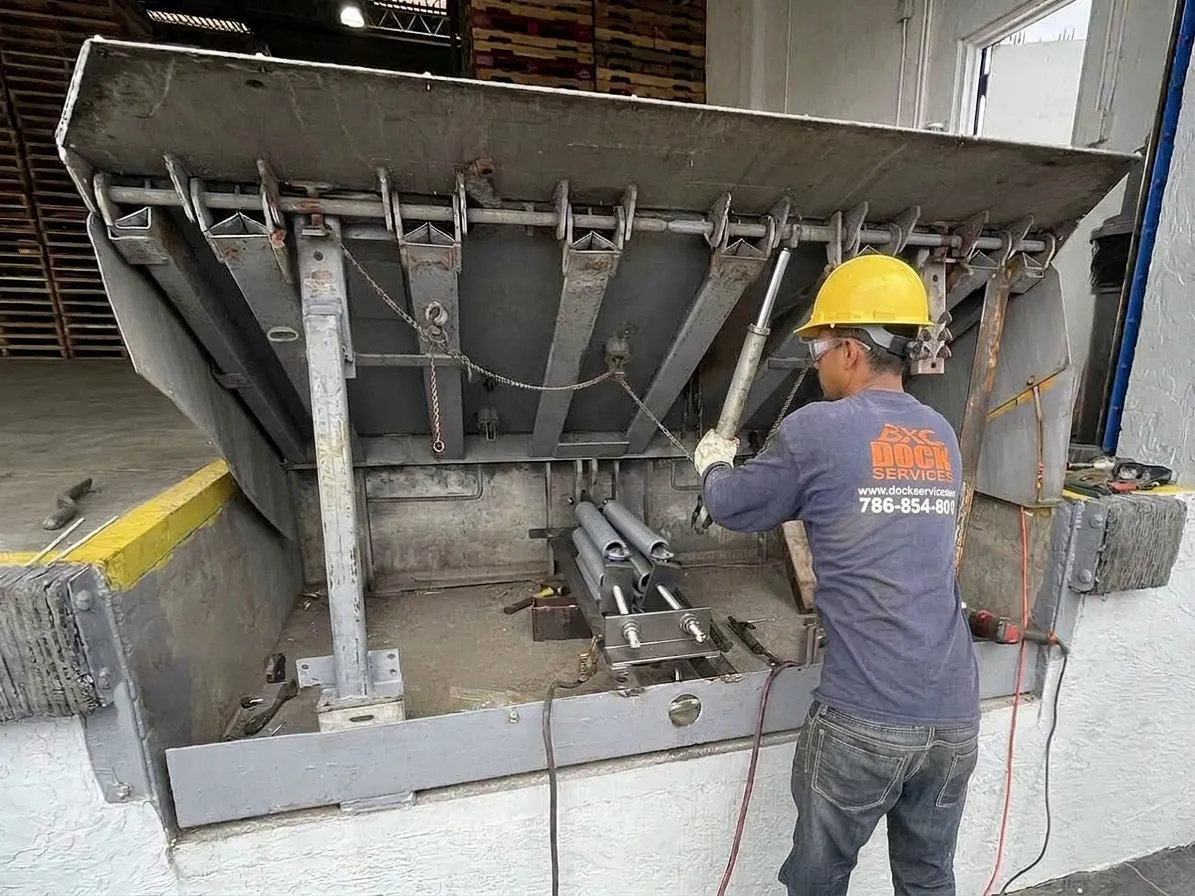 Technician converting an older Kelley PowerPak pit leveler to spring operation